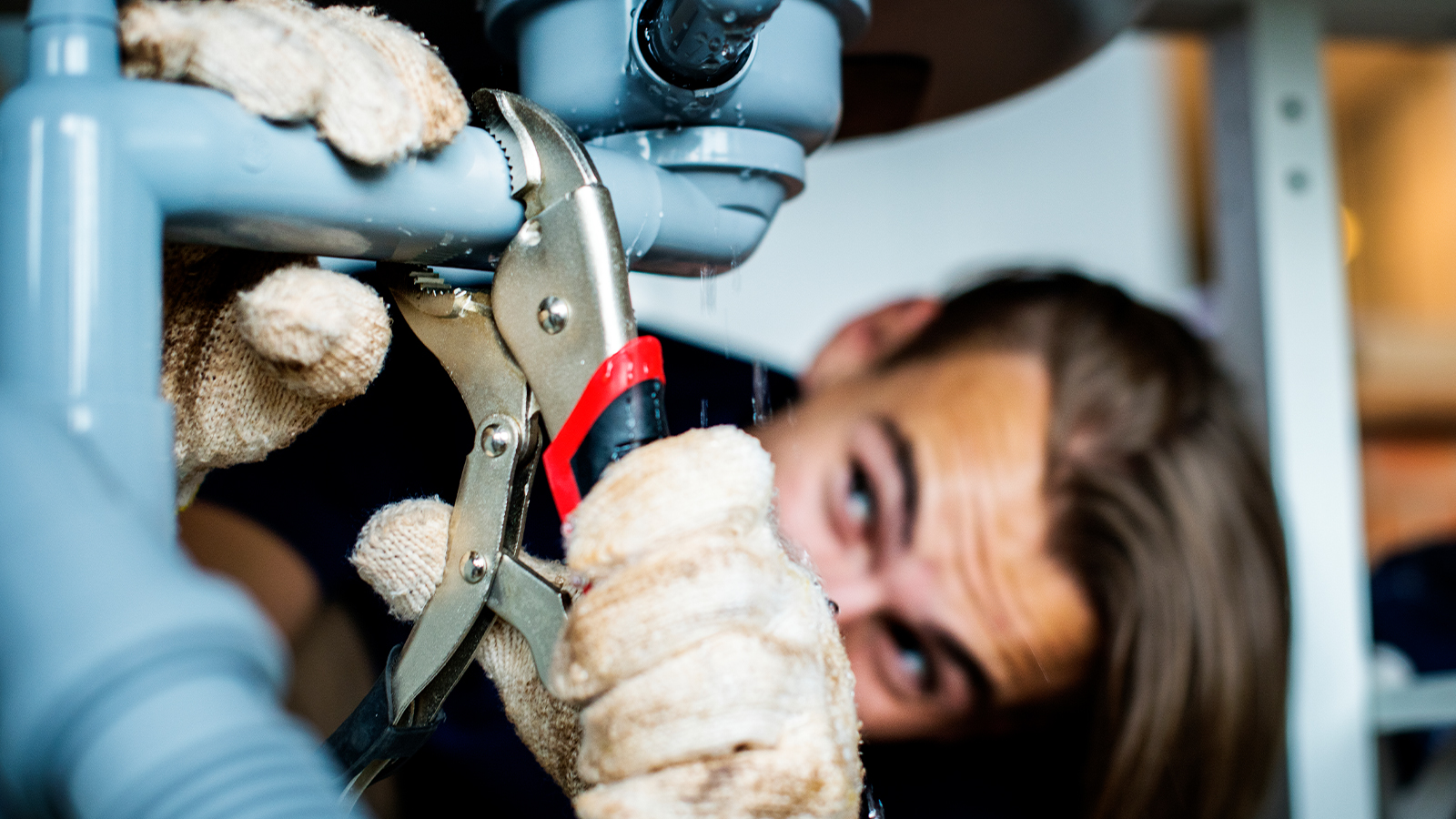 Contractor Setting Up Plumbing in Garage Bathroom